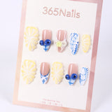 365Nails Butter Yellow Floral Carving with Blue‑White Porcelain Patterns, Jelly Beads & French Mix – Fresh Medium Almond Press‑On NailsSold in packs of 5. Minimum order: 1 pack (5 pcs). Quantity = number of packs. Qty 1 = 5 pcs