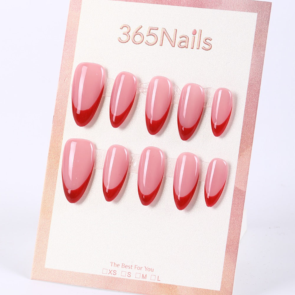 Uñas postizas almendradas 365Nails, color rosa nude con punta francesa roja.