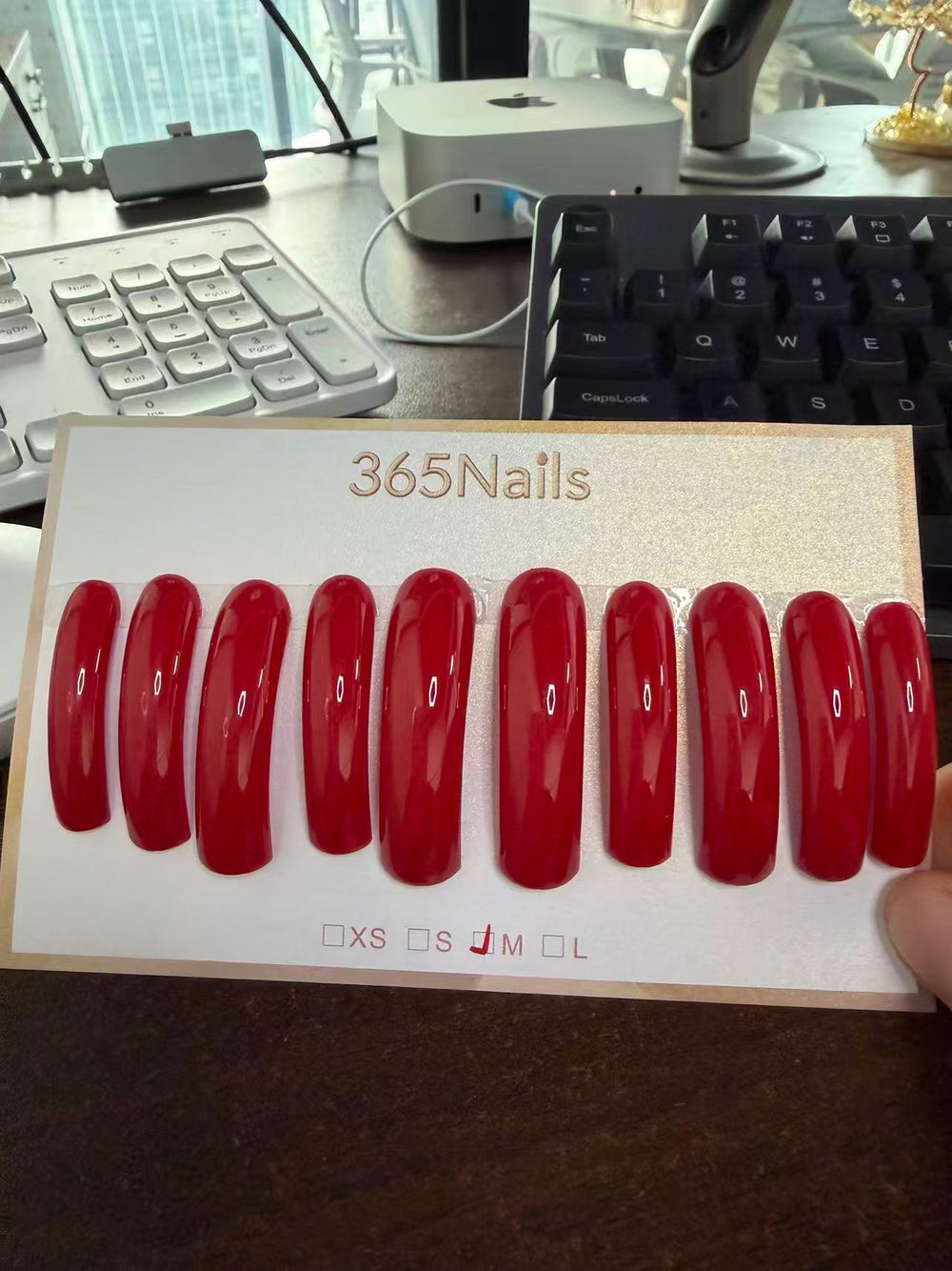 Glossy red long coffin press-on nails displayed as a finished product, suitable for wholesale supplier quality comparison articles