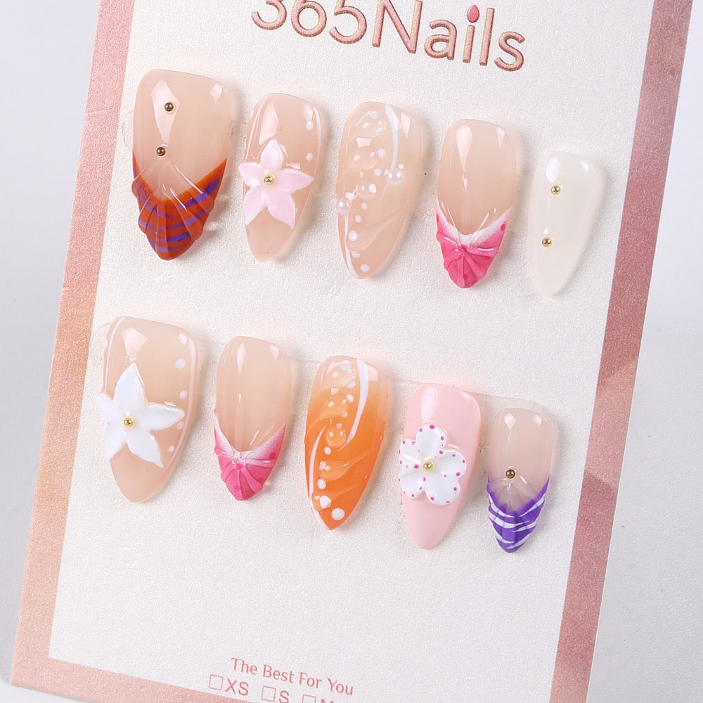 Peachy nude press-on nails with hand-painted flowers and ribbon folds, example of ODM custom design collaboration.