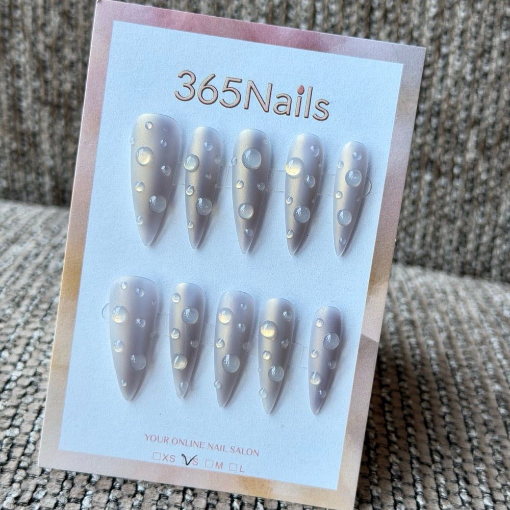 Lavender grey handmade press-on nails with pearl dot accents displayed on a neutral background, representing wholesale quality inspection examples.