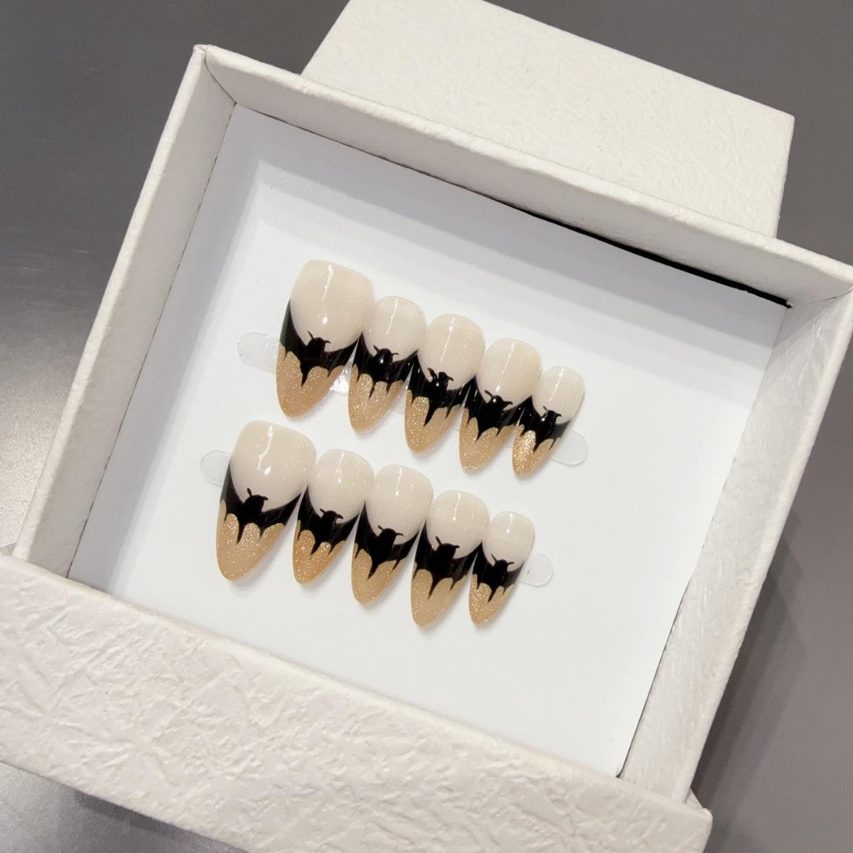 Black 3D bow handmade almond press-on nails with glossy finish, suitable for custom ODM nail collection inspiration