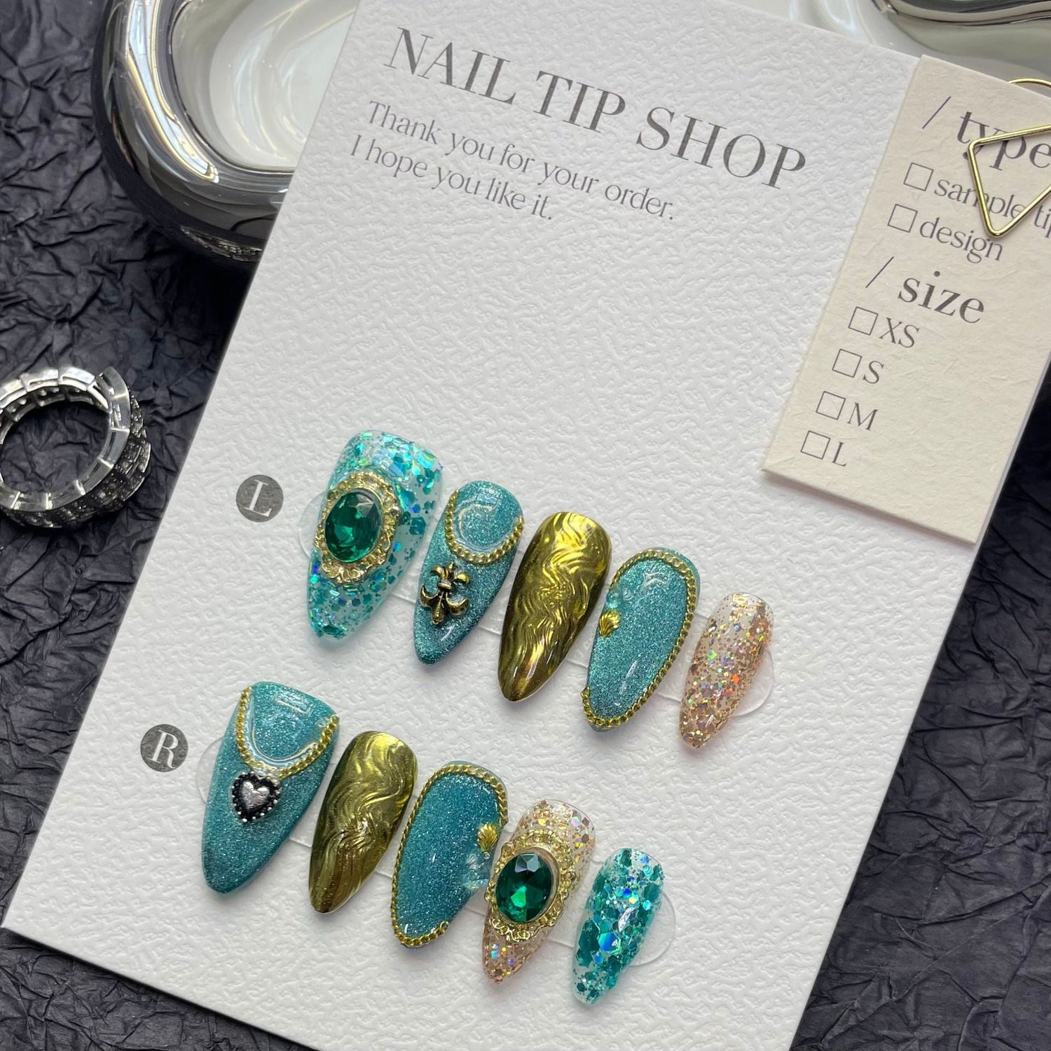 Custom ODM press-on nails with exotic turquoise, gold accents, and gem details.