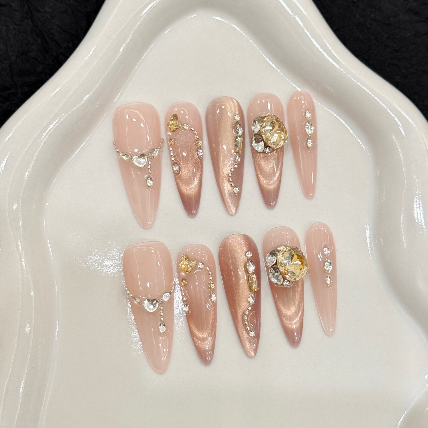 Luxury champagne cat-eye stiletto press-on nails with 3D diamond and gold chain accents, illustrating custom ODM nail design detail.
