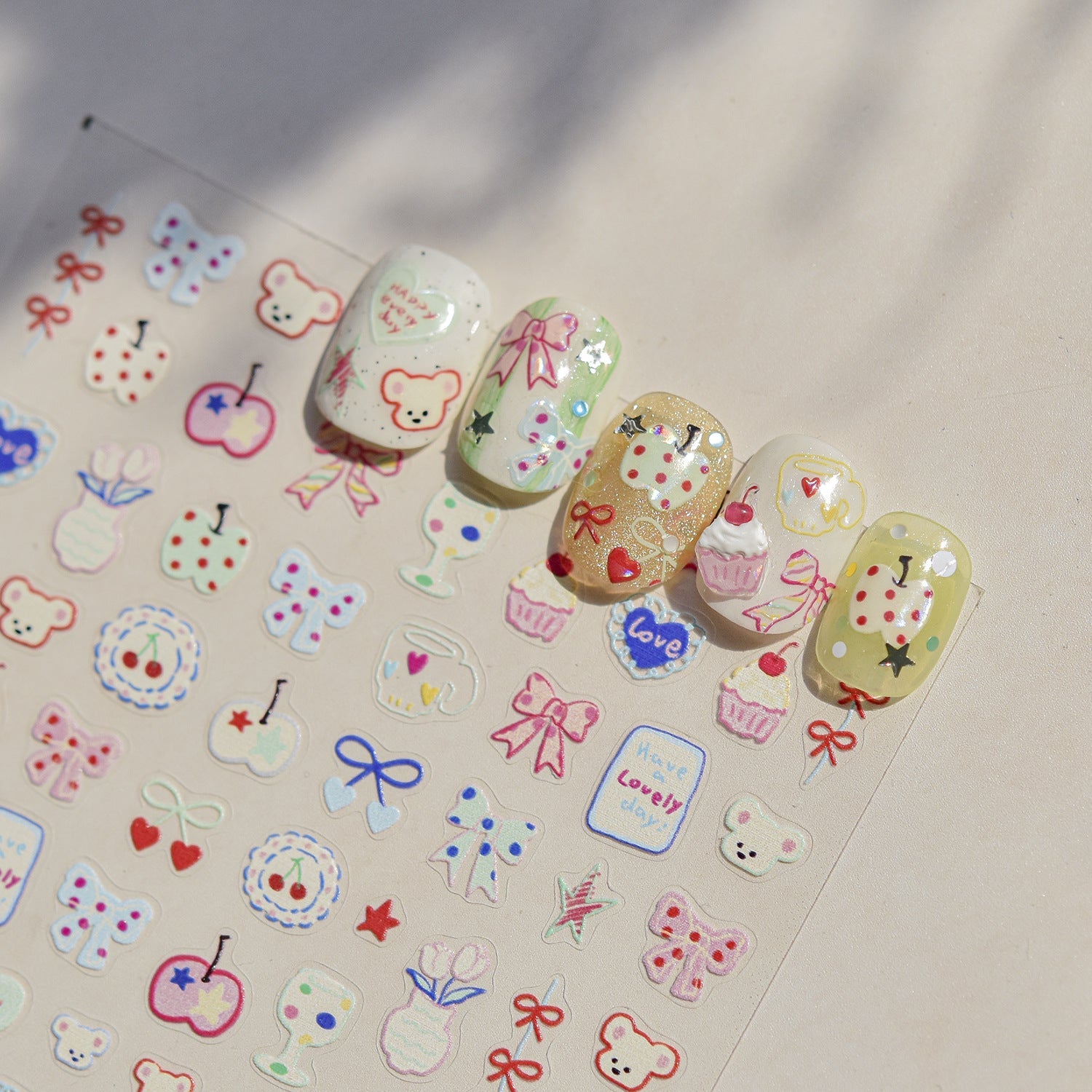 Assortment of colorful and cute press-on nail sets featuring bear and sweet treat designs, ideal for salon retail testing