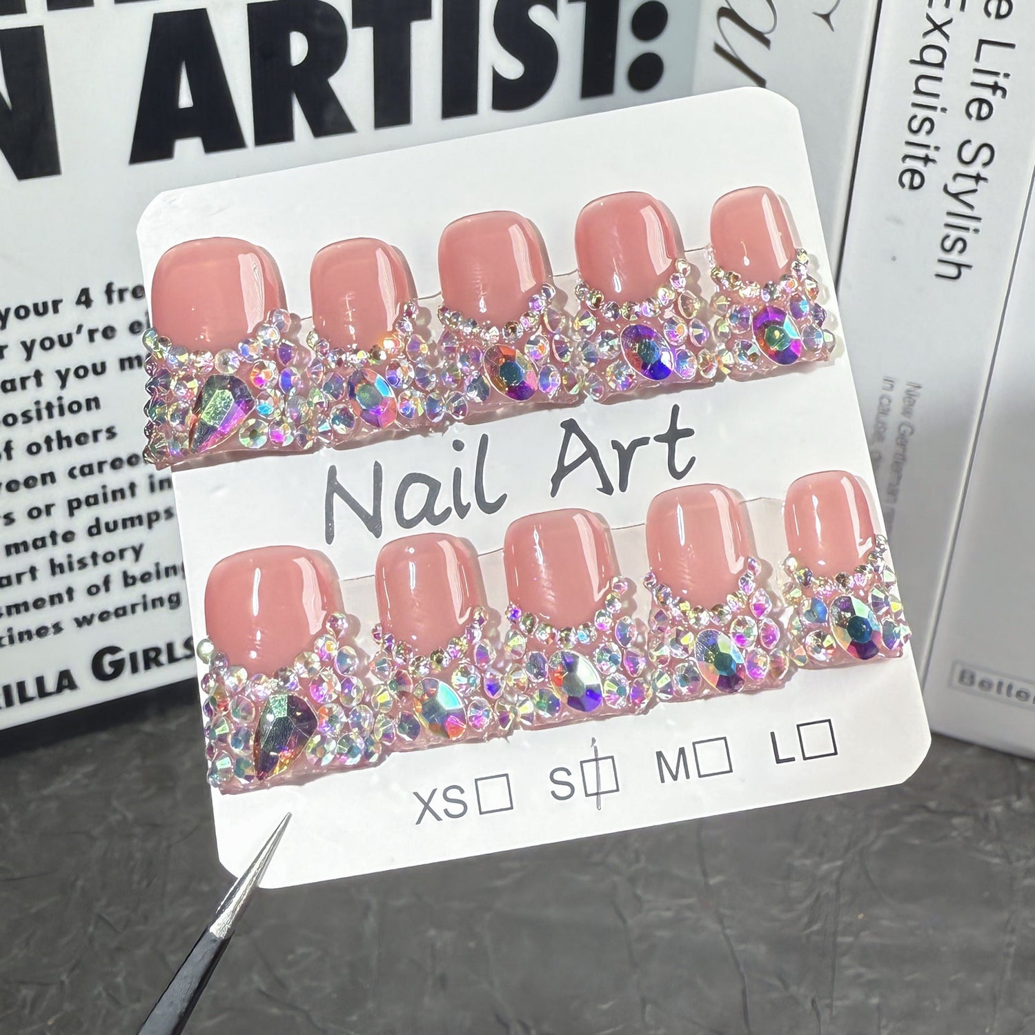 Short icy French press-on nails with crystal rhinestone tips on a neutral background