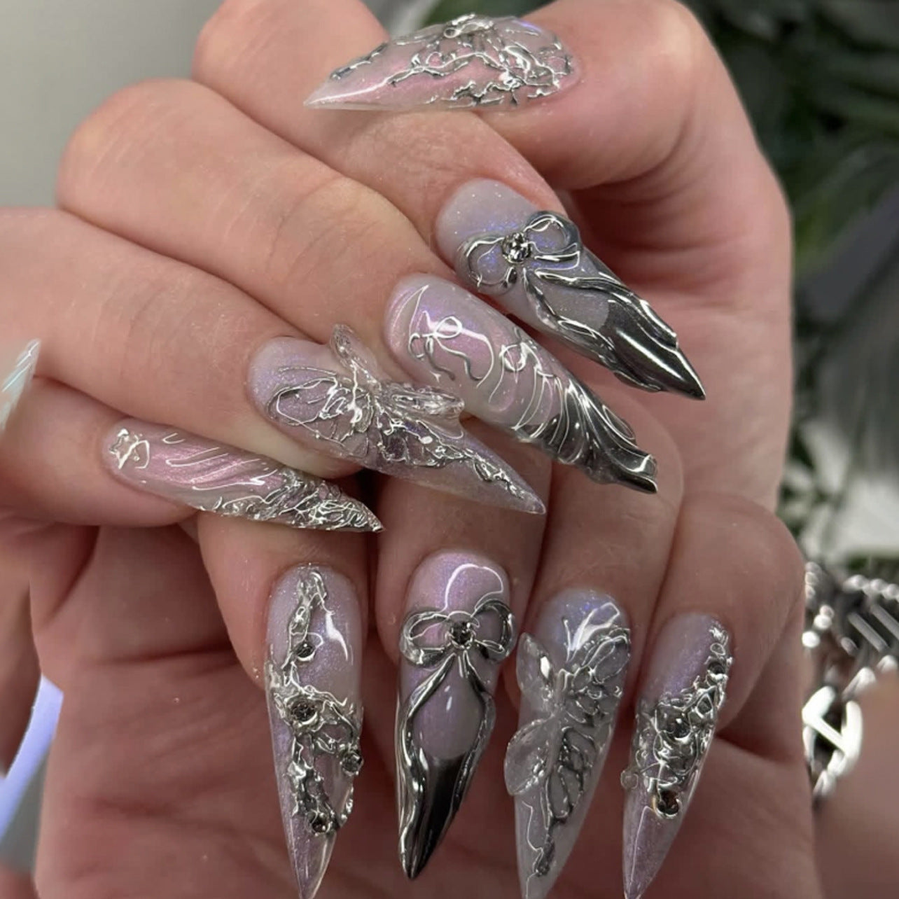 Silver chrome 3D butterfly stiletto fantasy press-on nails, a luxurious custom nail example for ODM design brief planning.