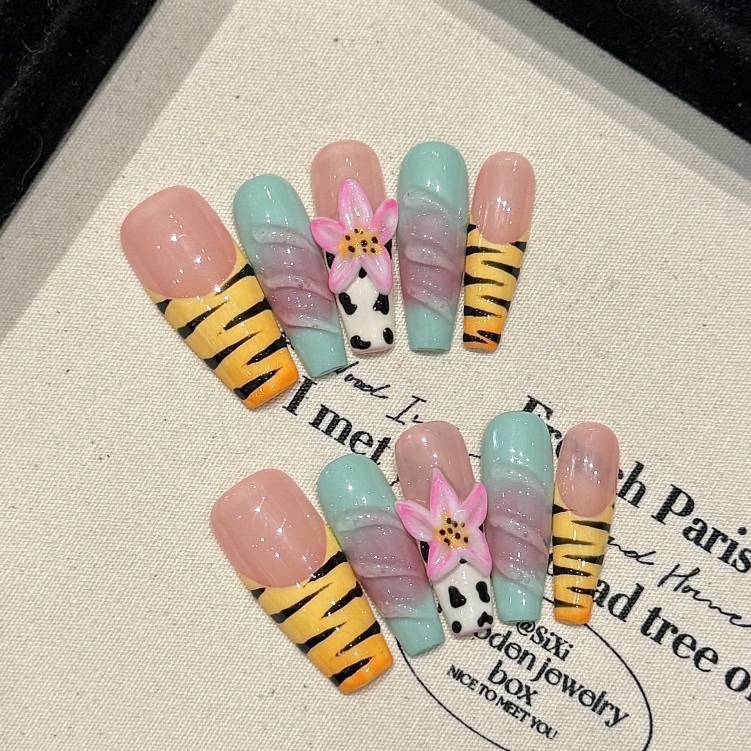 Pastel zebra press-on nails with 3D lotus and colorful stripes, square shape, on a white background for wholesale catalog comparison.