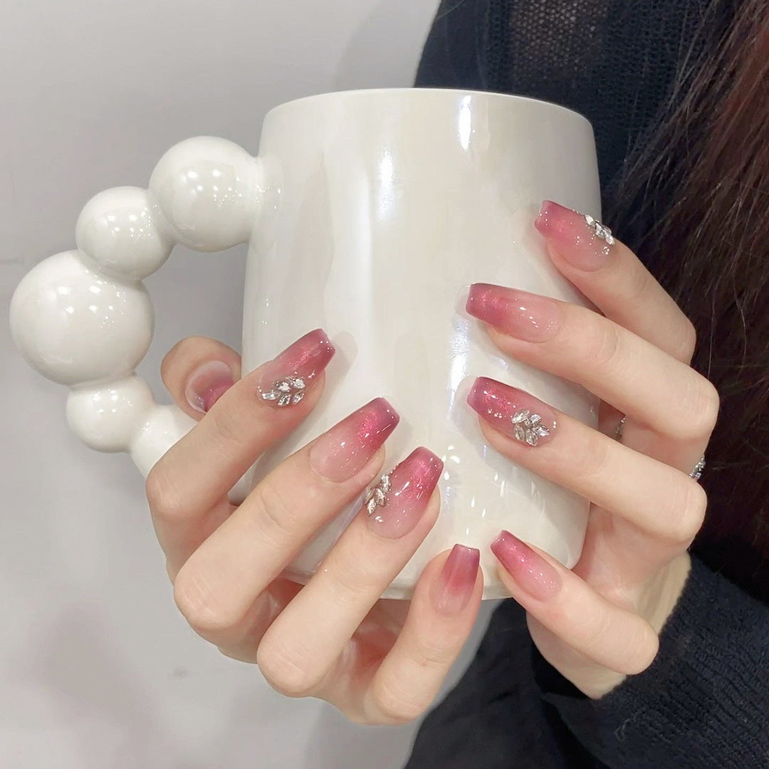 Handpainted cat eye gradient and gem handmade medium almond nails, perfect as an example of custom ODM press-on nail production.