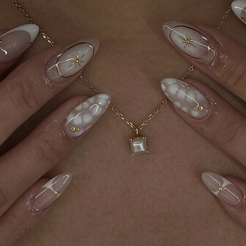 3D Bohemian French White Short Almonds press-on nails on a model's hand with a floral design