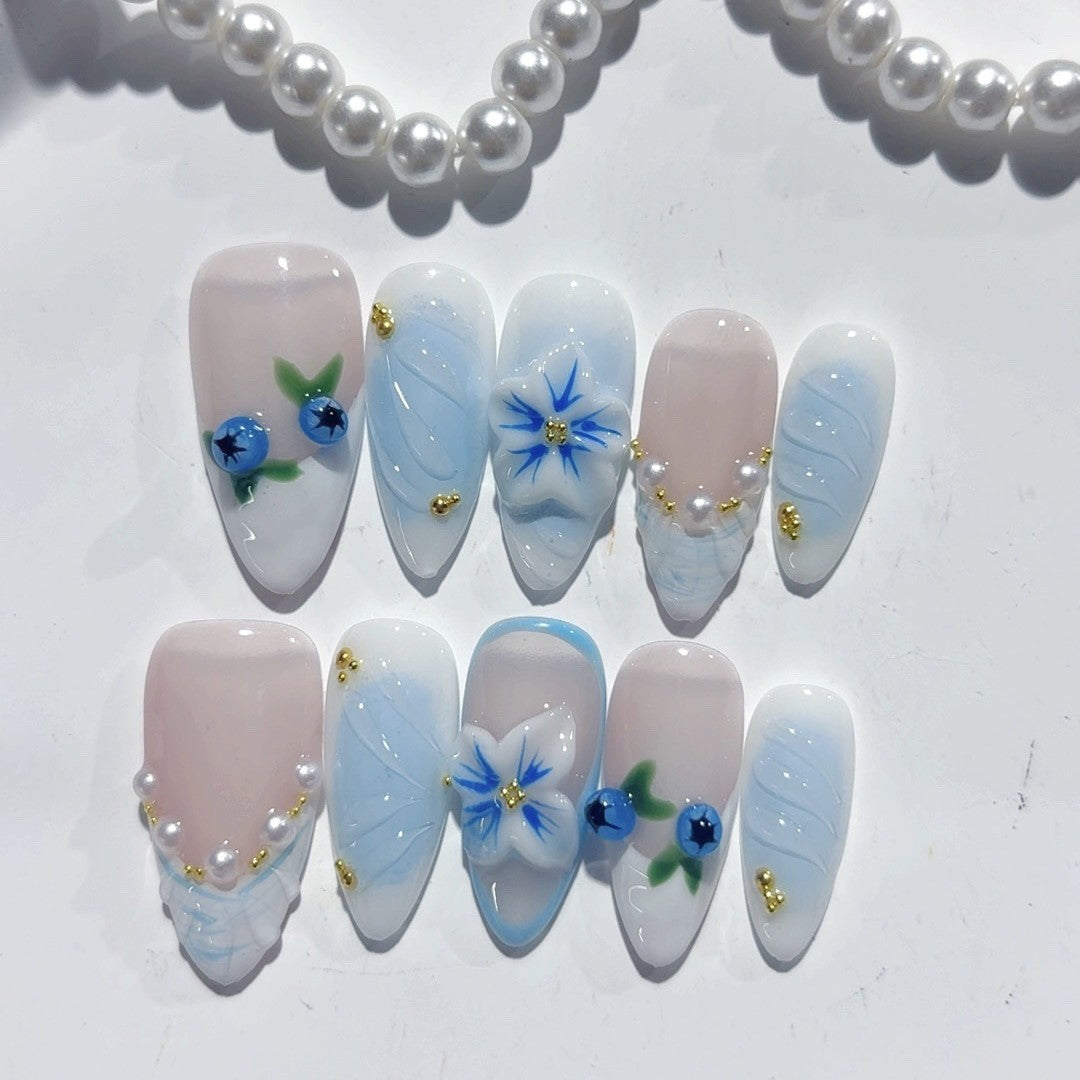Handmade almond press-on nails with blueberry gradient, 3D flower, and gold stud accent