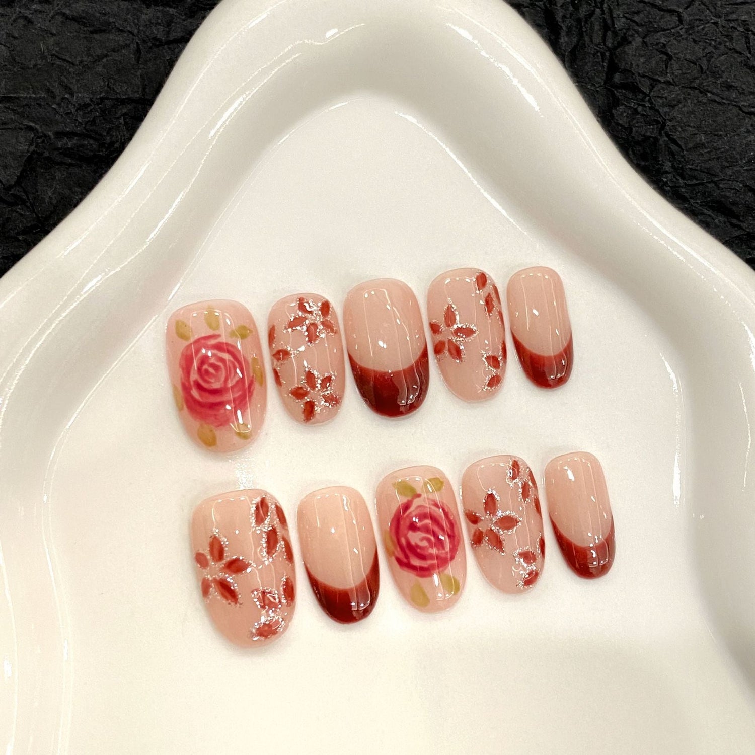 Hand-painted vintage rose floral French tip almond press-on nails, perfect for salon wholesale assortment.