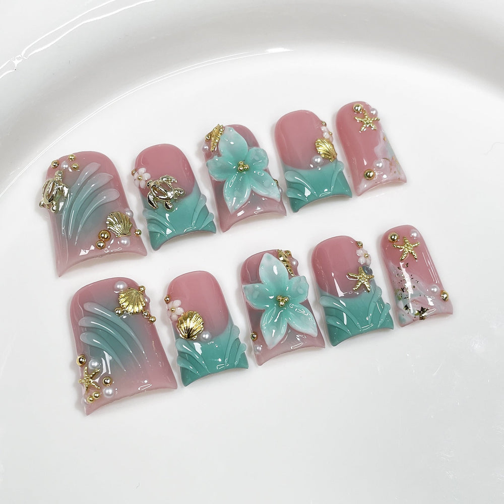 Aqua Bloom Seashell Series Press-On Nails in blue and gold on neutral background, suitable for salon retail wholesale assortment.