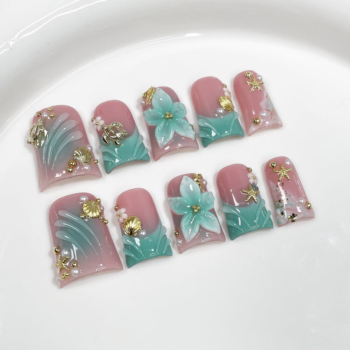 Aqua Bloom Seashell Series Press-On Nails in blue and gold on neutral background, suitable for salon retail wholesale assortment.