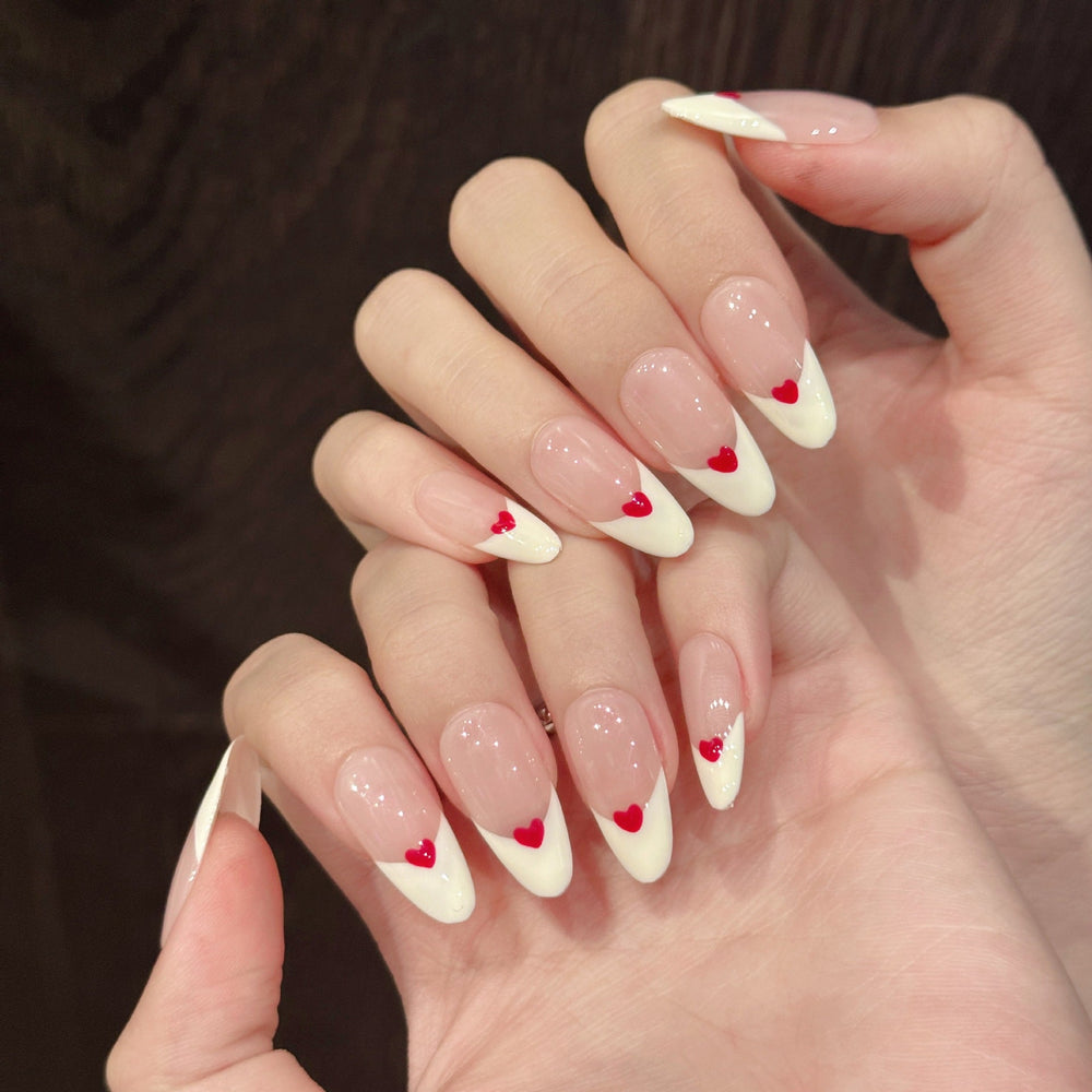 Handmade almond press-on nails with 3D heart French tips and pink and red romantic design, suitable for private label brand packaging and salon retail display planning.