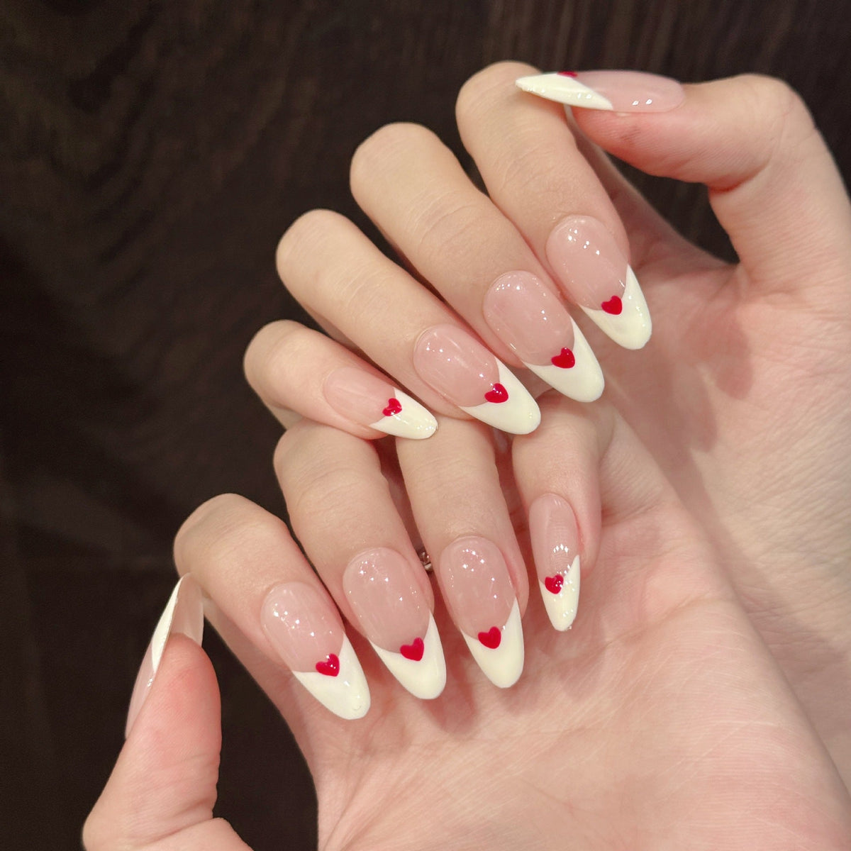 Handmade almond press-on nails with 3D heart French tips and pink and red romantic design, suitable for private label brand packaging and salon retail display planning.