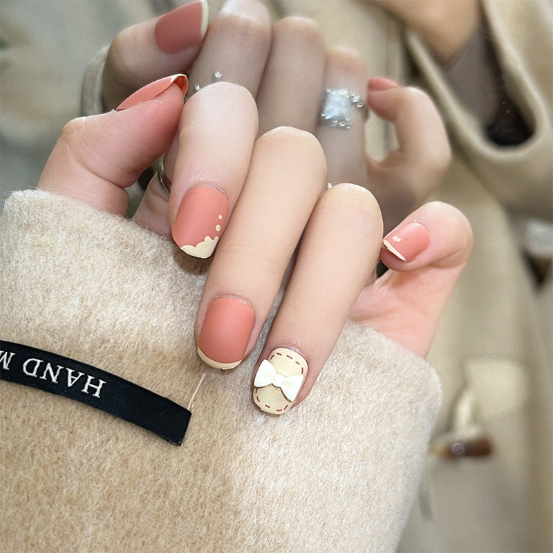 Neutral nail design worn on a hand