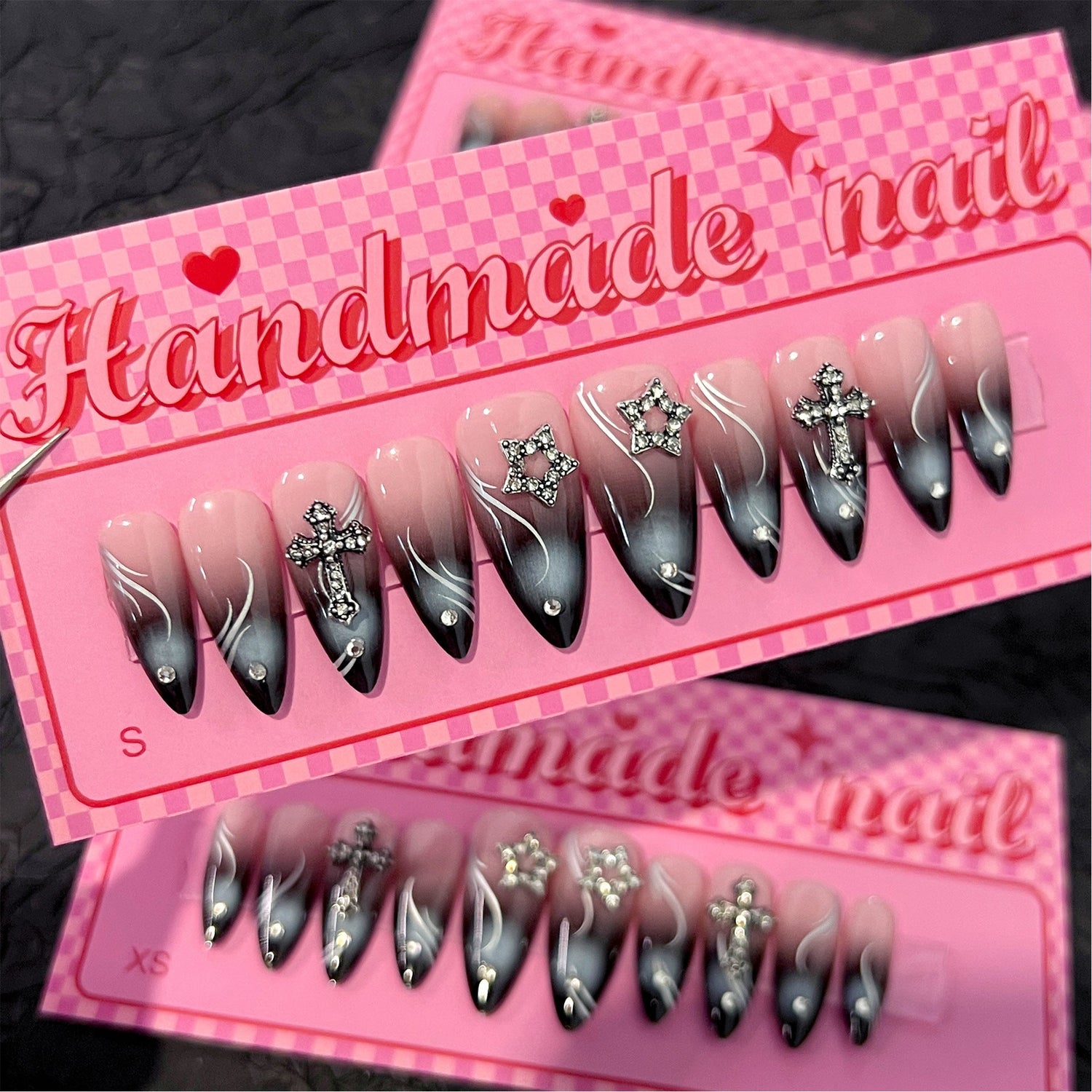 Red and black ombre flame-inspired stiletto press-on nails with silver cross charms and rhinestones, representing a supplier communication transparency checklist for wholesale press-on nail sourcing.