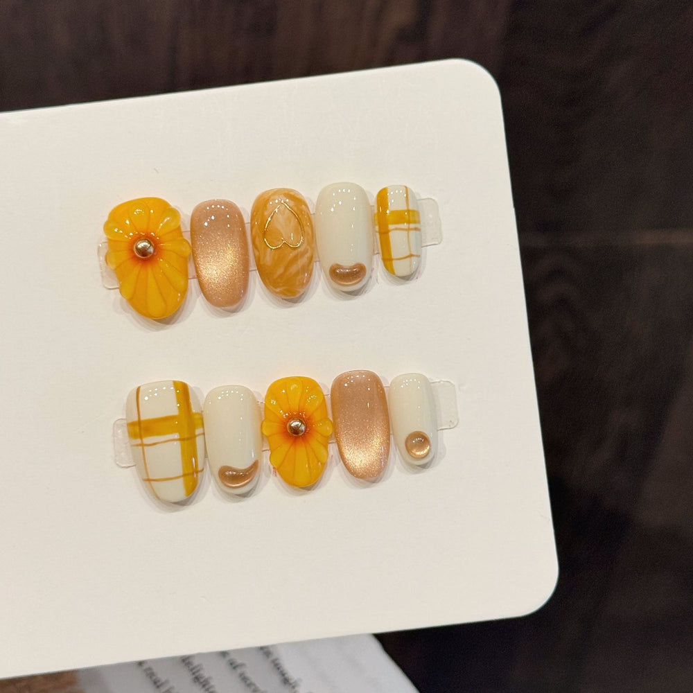 Yellow plaid flower cute press-on nails in short oval shape with glossy finish, ideal for wholesale salon retail assortment.