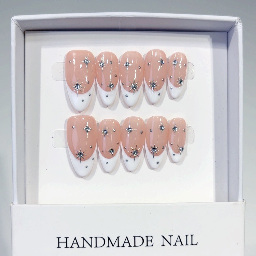 Silver star French almond press-on nails with rhinestones and cool-toned gel polish, ideal for online sellers seeking salon-quality wholesale products.