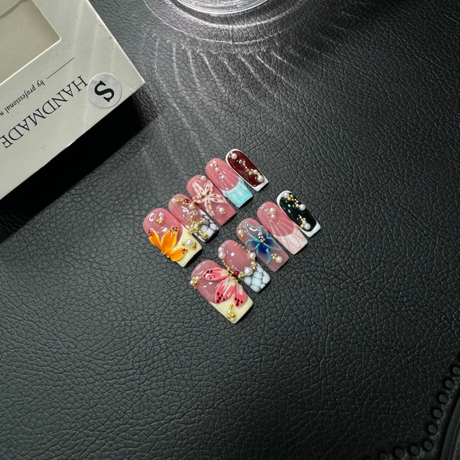 Handmade 3D floral coffin press-on nails with pink and blue blossoms against a light background, suited for private-label dropshipping product images.