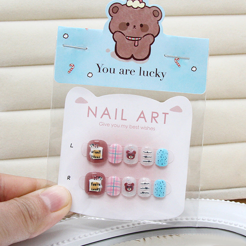 Brown three-dimensional bear cat-eye kids press-on nails on a wooden surface, demonstrating machine-made press-on nail quality.