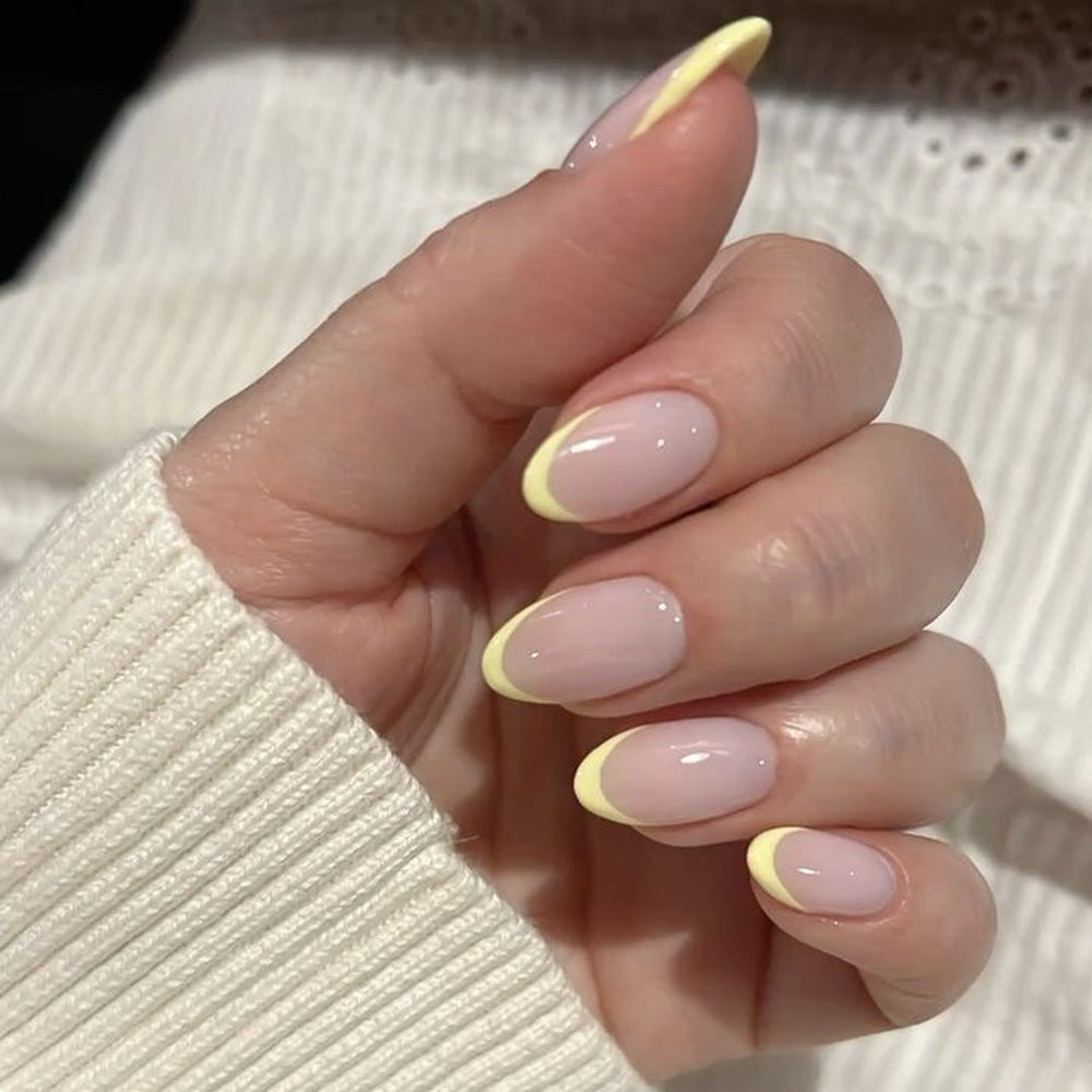 Soft pink almond press-on nails with yellow French tip glow, finished nail set for wholesale salon retail