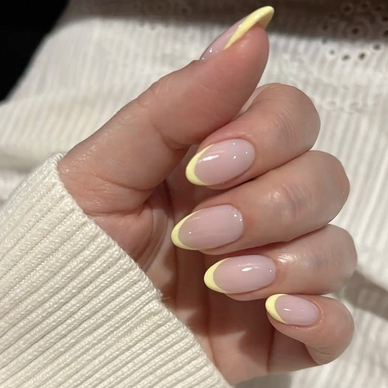 Soft pink almond press-on nails with yellow French tip glow, finished nail set for wholesale salon retail