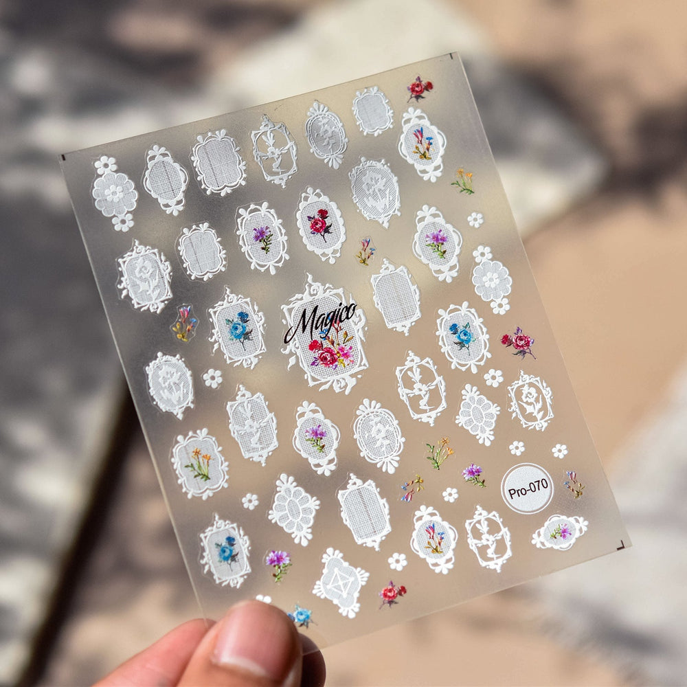 Finished private-label press-on nail sample with delicate white lace floral design on sheer pink background, laid out for supplier packaging approval.