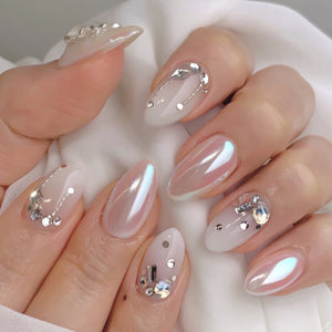 Iridescent pearl chrome crystal almond press-on nails arranged as a wholesale set, showing glossy silver, pearl, and crystal finishes in multiple sizes.