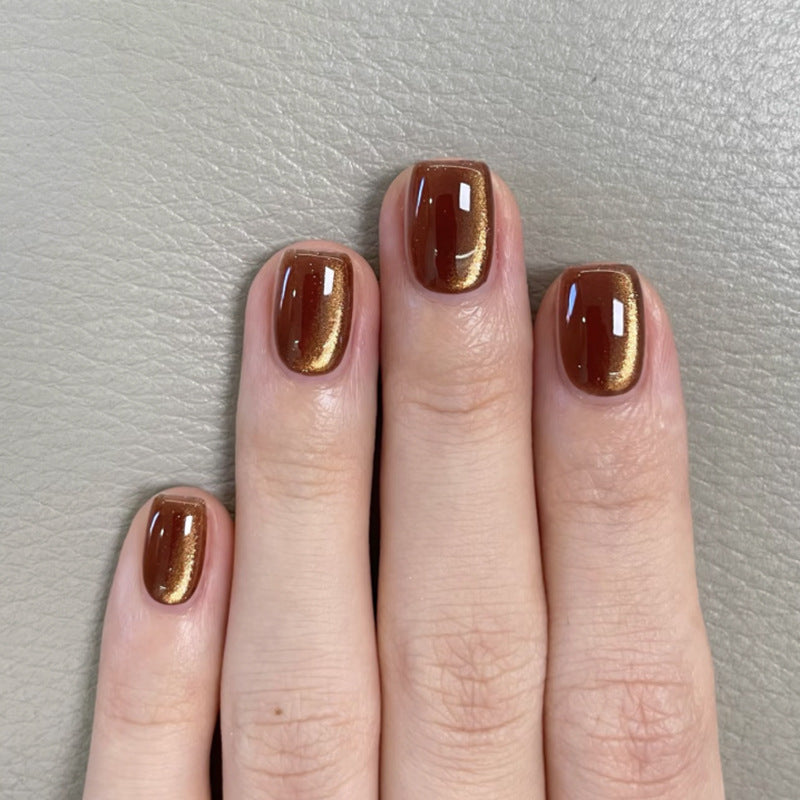 Shimmer brown cat-eye press-on nails with a glossy elegant finish, displayed on a squoval shape – a popular choice for salon retail clients.