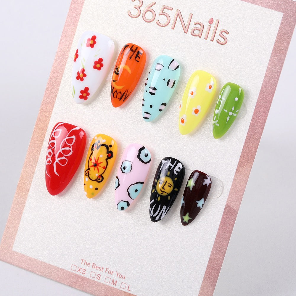 Colorful hand-painted press-on nails with graffiti flowers and stars, ideal for a diverse wholesale nail order