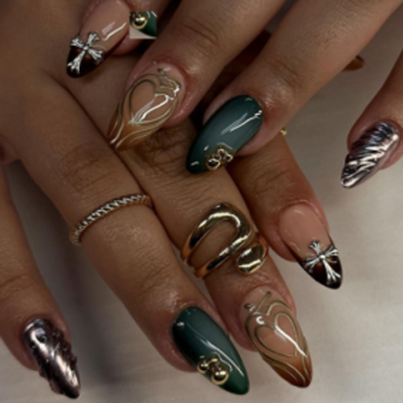 Private label press-on nail design example: Maillard brown and hunter green French tips with 3D chrome cross, perfect for a brand launch