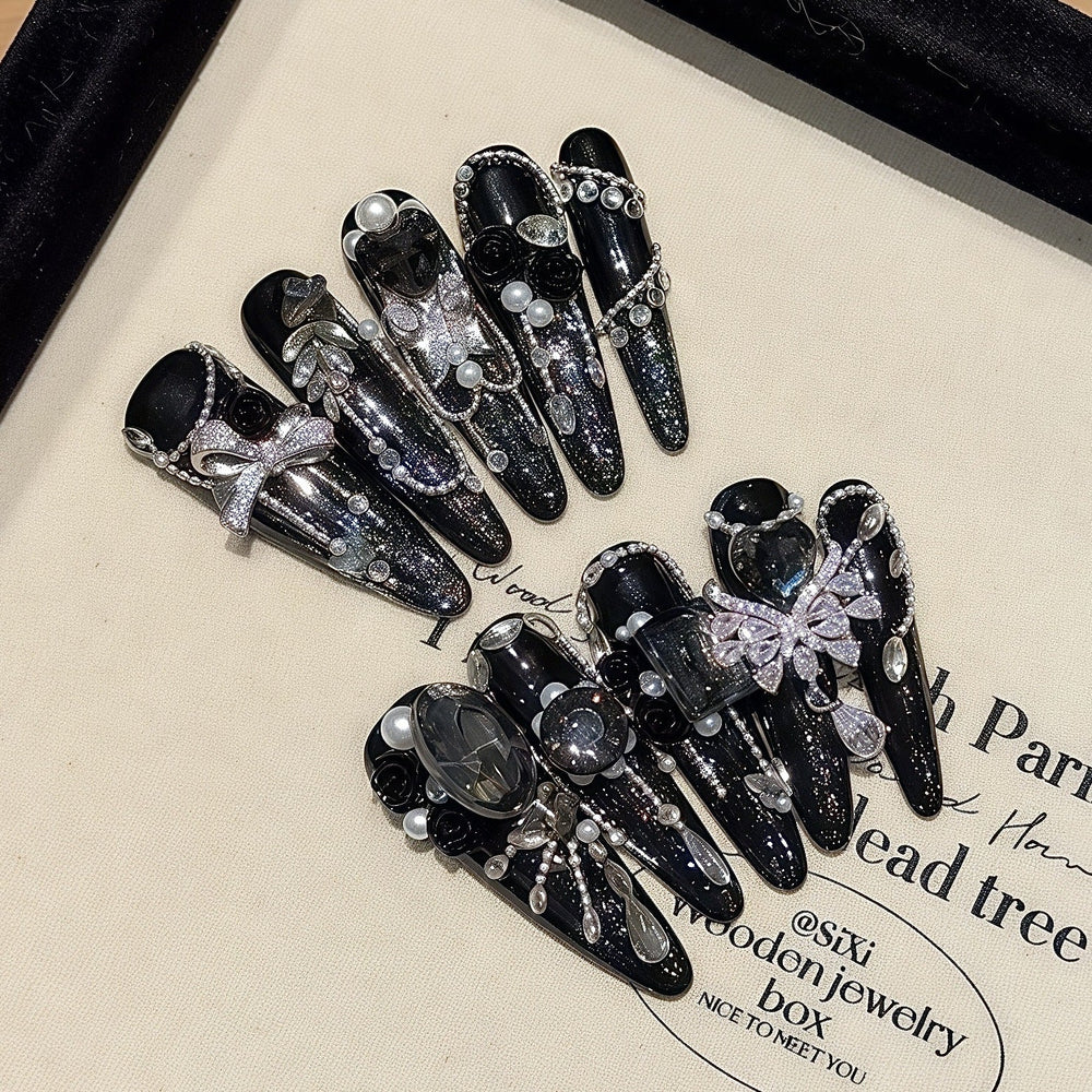 Luxury dark zircon rhinestone stiletto press-on nails set displayed in a box, ideal for private label brand launch content and unboxing campaigns.