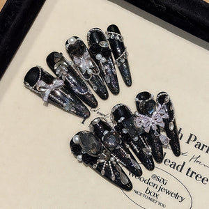 Luxury dark zircon rhinestone stiletto press-on nails set displayed in a box, ideal for private label brand launch content and unboxing campaigns.