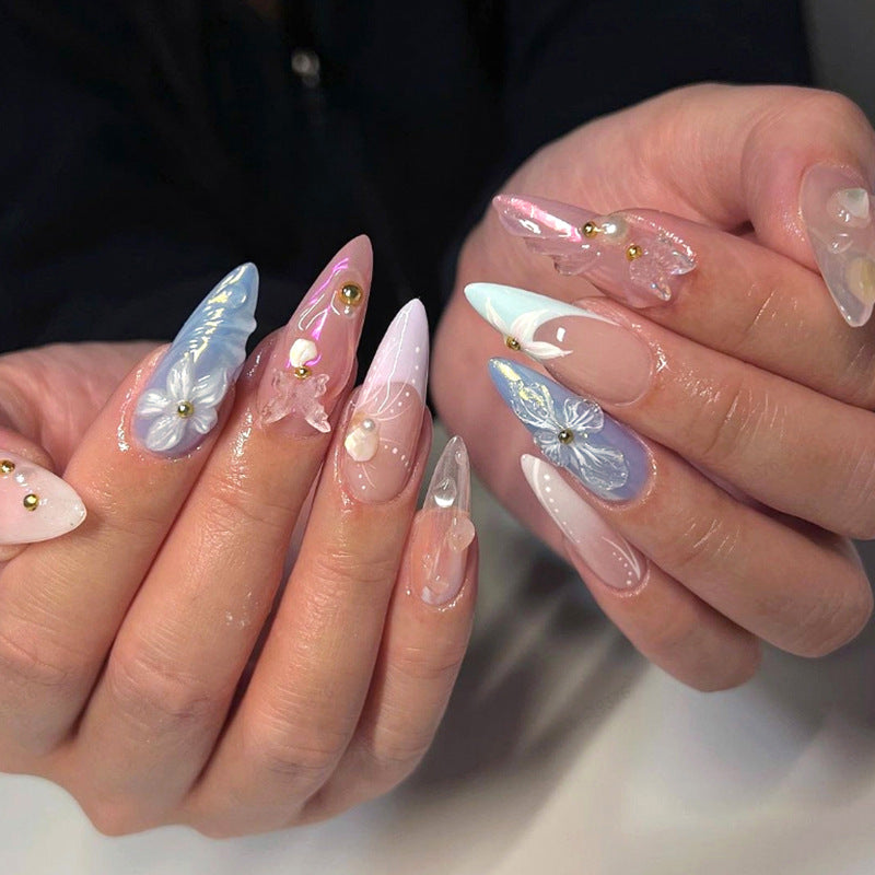 Custom ODM press-on nails featuring dreamy 3D water ripple French tips with butterfly, floral and pearl accents