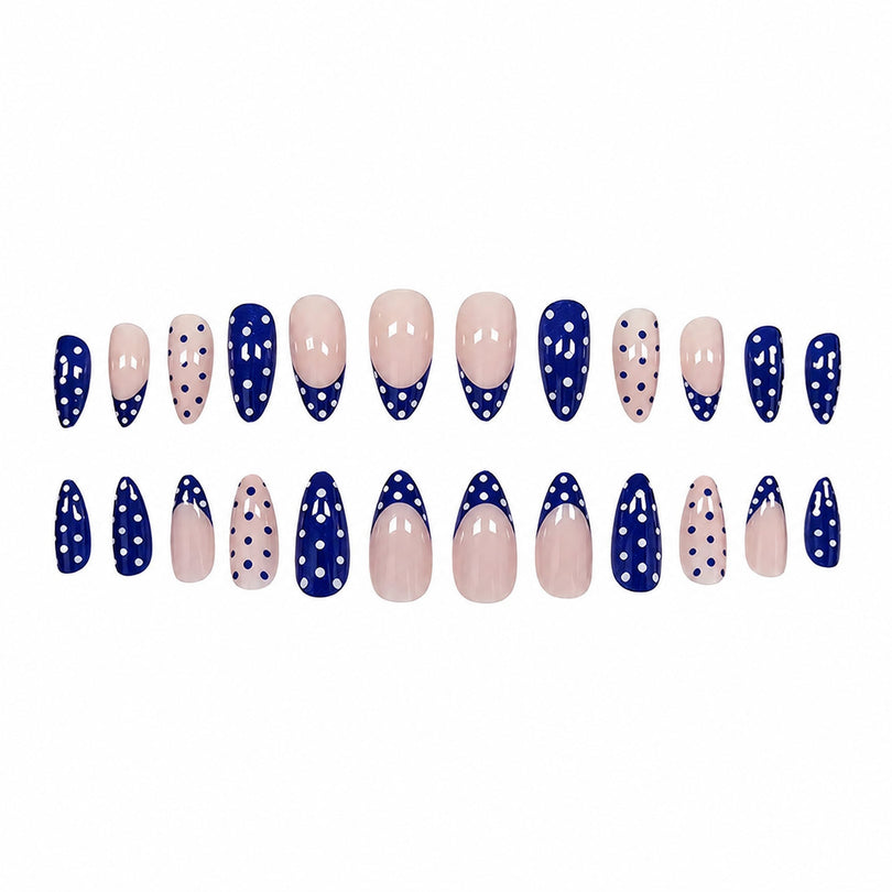Twenty-four press-on nails arranged in two rows with blue and nude polka dot patterns