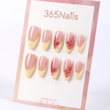 Uñas postizas almendradas 365nails con base color nude, francesa amarillo mantequilla y flores pintadas a mano.