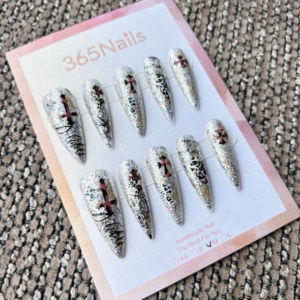 Femme Fatale: "Gilded Rebel" – Silver Holographic Glitter Base with Bronze Crosses & Black Leopard Graffiti Long Stiletto Nails