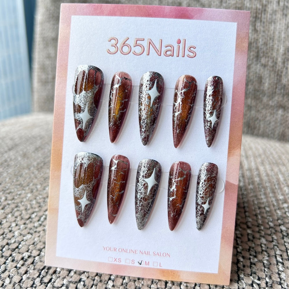 Femme Fatale: "Amber Galaxy" – Deep Bronze Cat Eye with Crushed Silver Foil & White Starburst Long Stiletto Nails