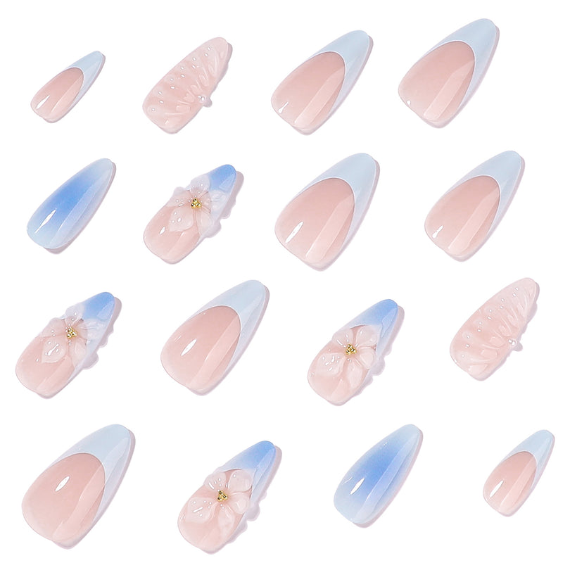 Individual press-on nails displayed on white background showing blue gradients and 3D flowers