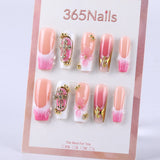 Nude pink gradient to pink and white French style with gold embellishment and three-dimensional knot press on nail