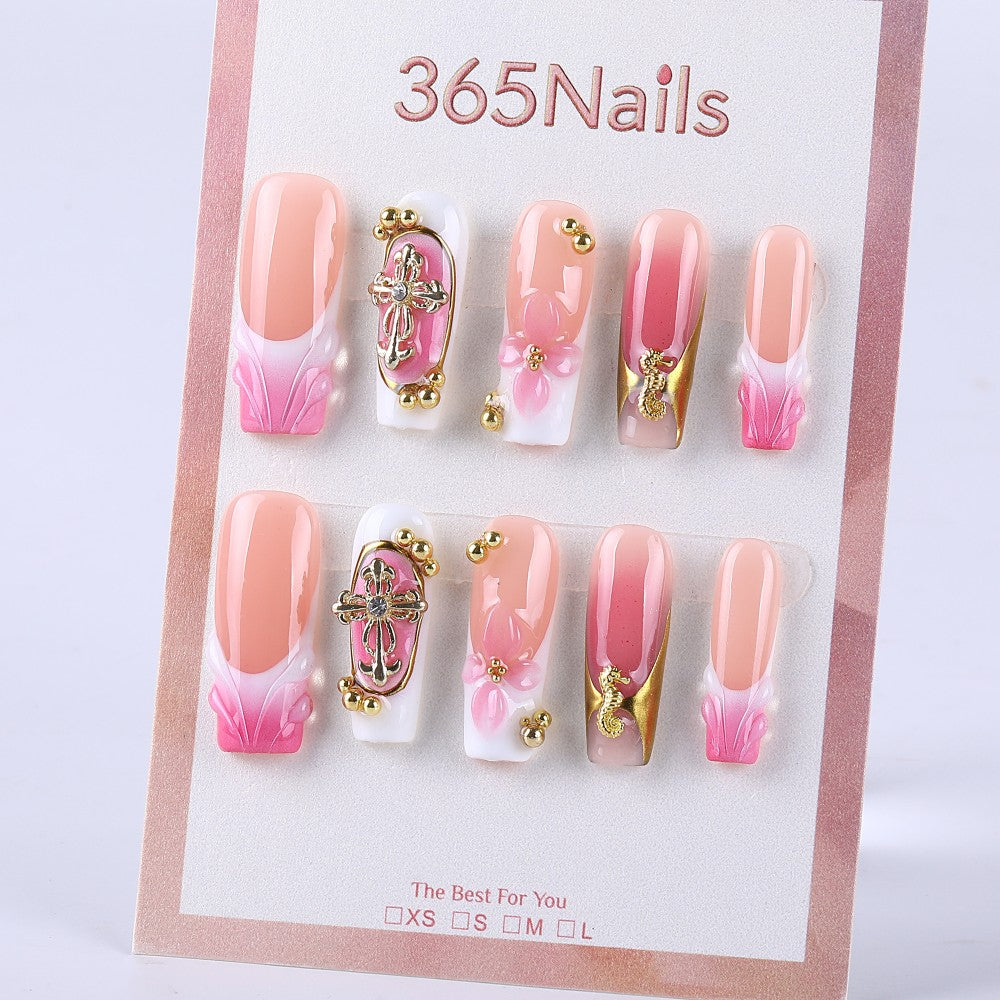 Nude pink gradient to pink and white French style with gold embellishment and three-dimensional knot press on nail