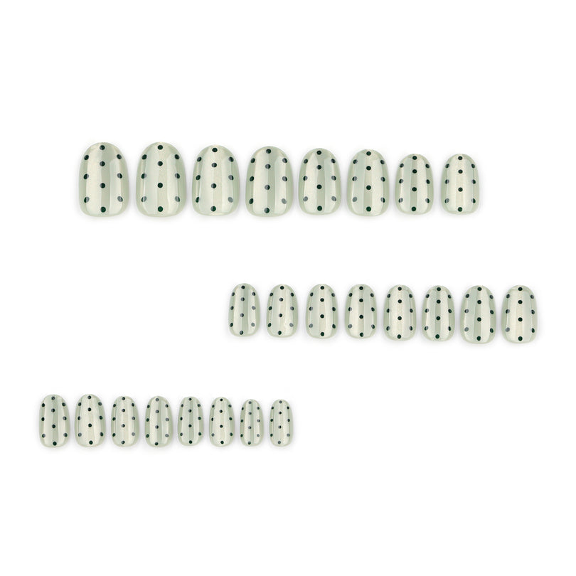 Set of glossy green dotted press-on nails arranged in three rows