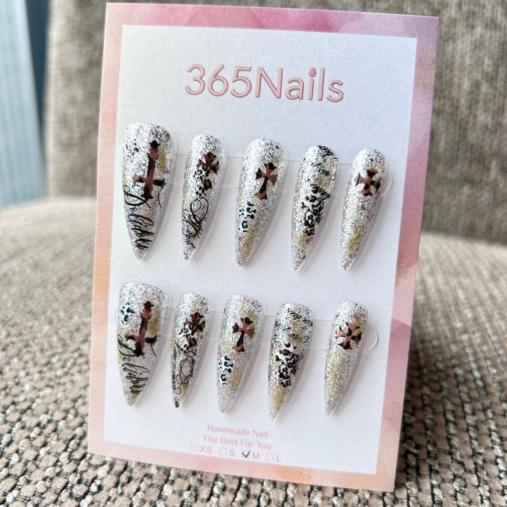 Femme Fatale: "Gilded Rebel" – Silver Holographic Glitter Base with Bronze Crosses & Black Leopard Graffiti Long Stiletto Nails