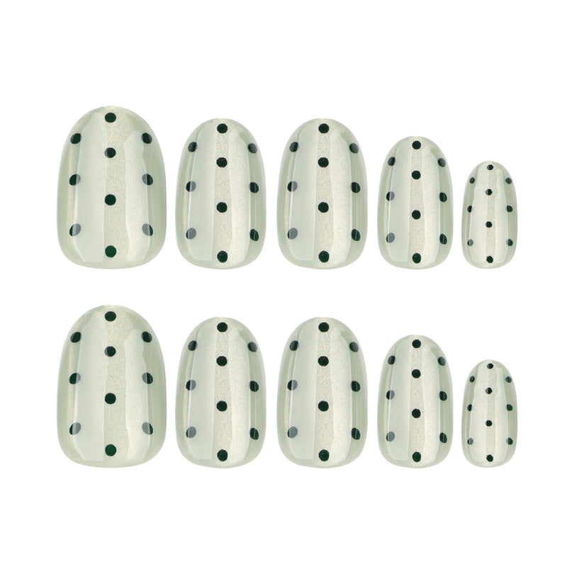 Green dotted press-on nails in five graduated sizes