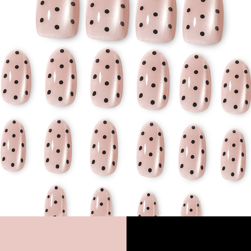 Grid of sheer pink cat-eye nails with black polka dots on white background
