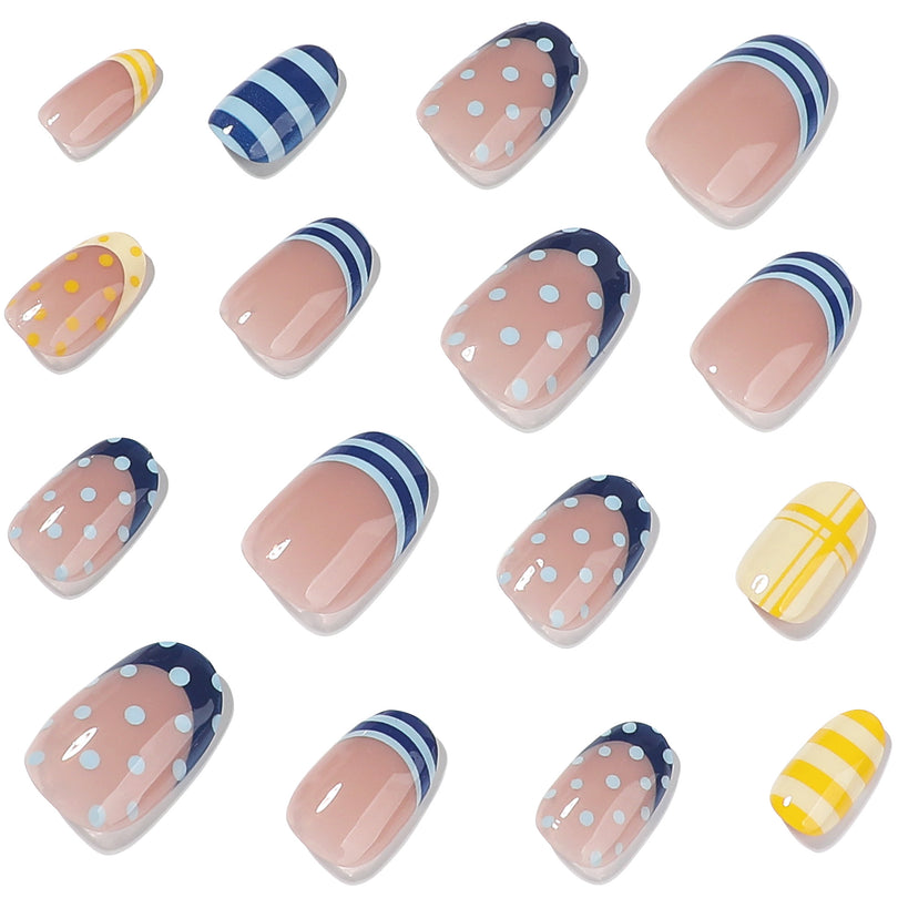 Scattered individual press-on nails with blue dot and yellow stripe patterns