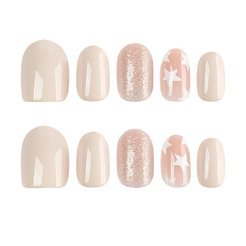 Two rows of press-on nails showing nude glossy, rose glitter, and white star pattern designs