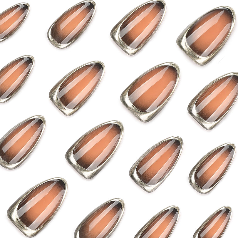 Close-up of multiple brown gradient almond nail tips with metallic edges.